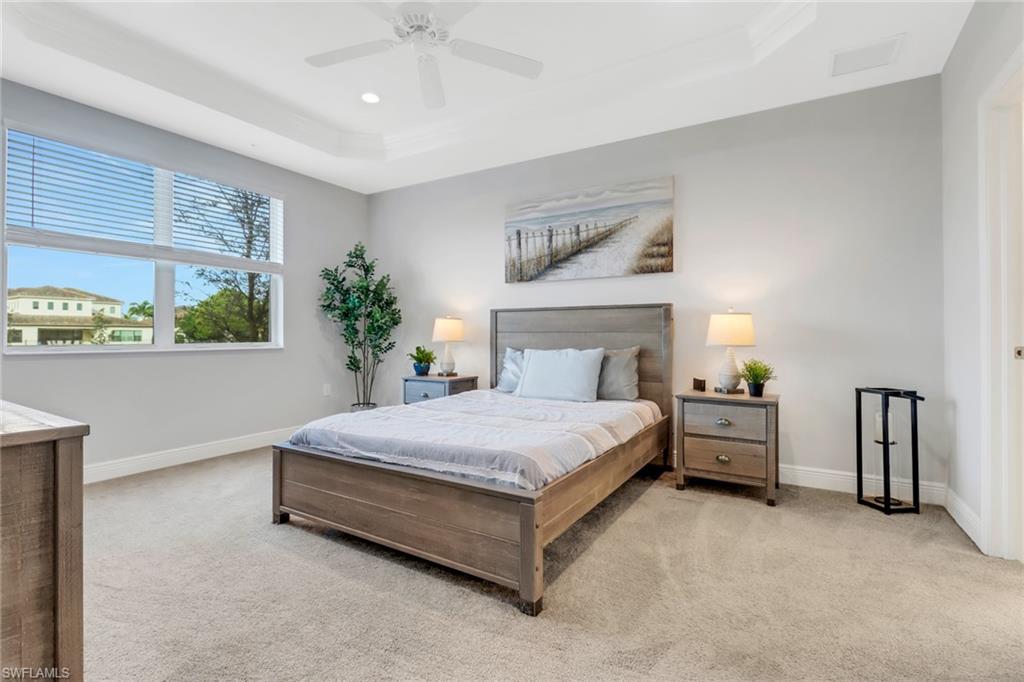 2295 Sawyers Hill Road, Unit 1002 Naples, FL 34120 - Photo 14 of 41 a spacious bedroom with a bed and window