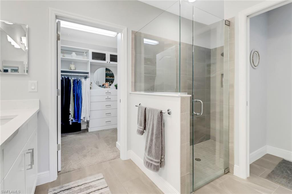 2295 Sawyers Hill Road, Unit 1002 Naples, FL 34120 - Photo 17 of 41 a view of walk in closet and bathroom