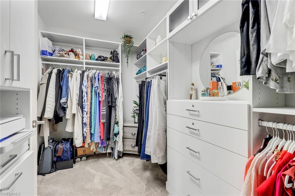 2295 Sawyers Hill Road, Unit 1002 Naples, FL 34120 - Photo 18 of 41 a view of walk in closet with clothes and shoes