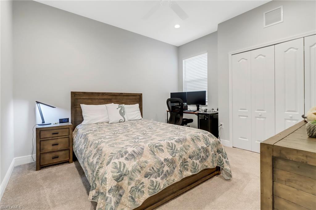2295 Sawyers Hill Road, Unit 1002 Naples, FL 34120 - Photo 19 of 41 a bedroom with a bed and dresser