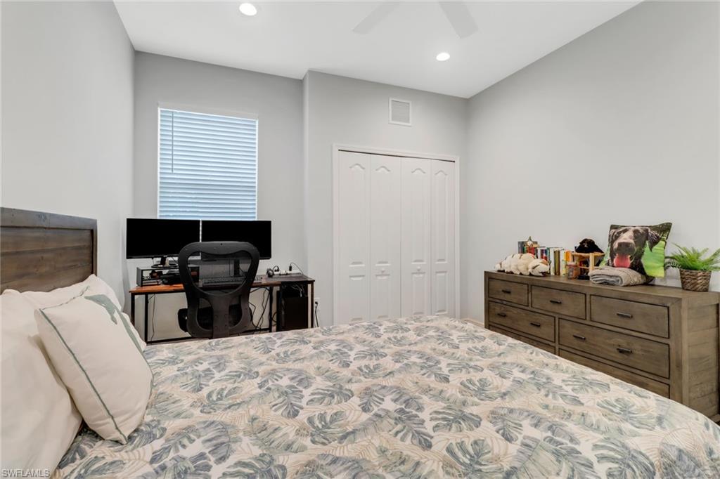 2295 Sawyers Hill Road, Unit 1002 Naples, FL 34120 - Photo 20 of 41 a bed room with a bed and a television