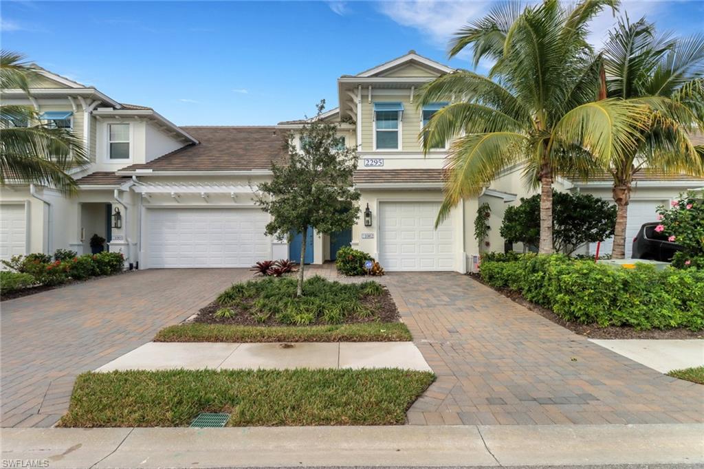 2295 Sawyers Hill Road, Unit 1002 Naples, FL 34120 - Photo 2 of 41 a front view of a house with garden