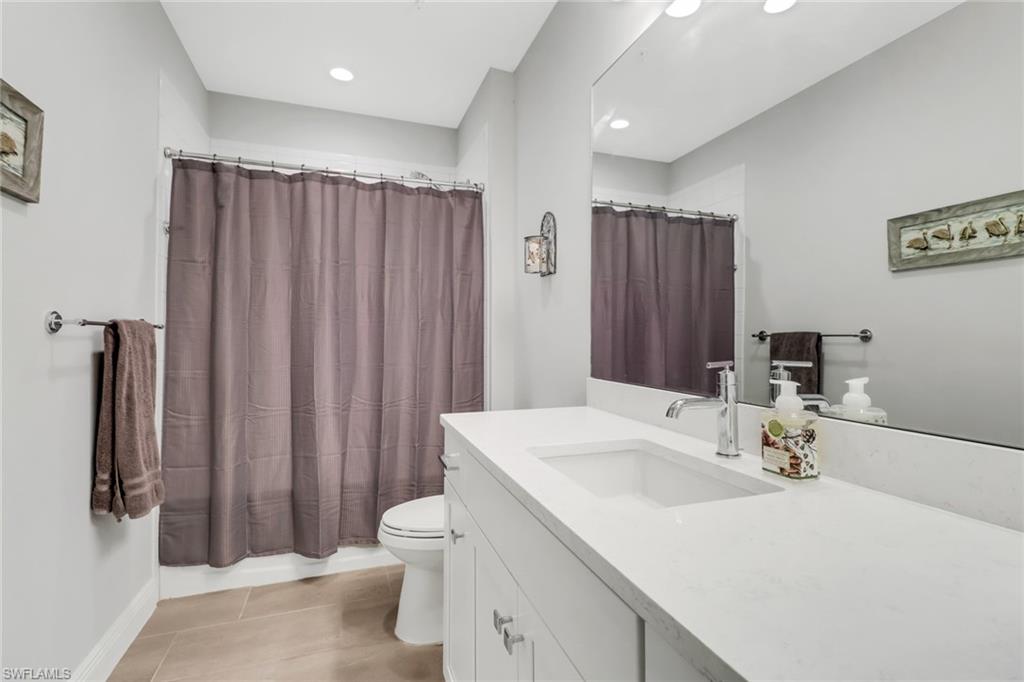 2295 Sawyers Hill Road, Unit 1002 Naples, FL 34120 - Photo 21 of 41 a bathroom with a sink a toilet and shower