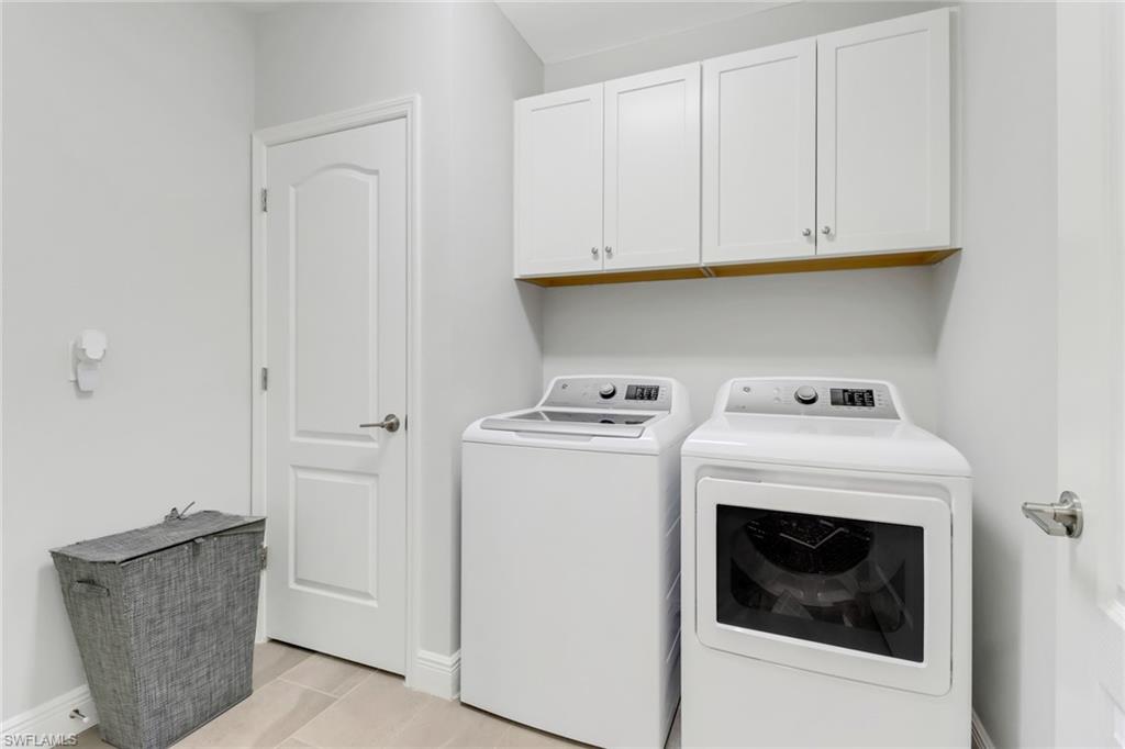 2295 Sawyers Hill Road, Unit 1002 Naples, FL 34120 - Photo 22 of 41 a utility room with dryer and washer