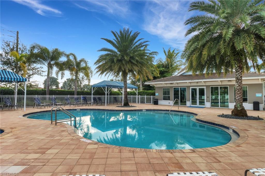 2295 Sawyers Hill Road, Unit 1002 Naples, FL 34120 - Photo 26 of 41 a view of a house with swimming pool and sitting area