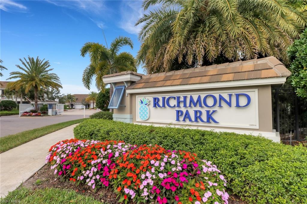 2295 Sawyers Hill Road, Unit 1002 Naples, FL 34120 - Photo 27 of 41 a sign that is sitting in front of flowers