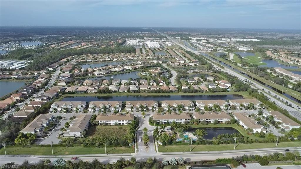 2295 Sawyers Hill Road, Unit 1002 Naples, FL 34120 - Photo 30 of 41 an aerial view of residential building and lake