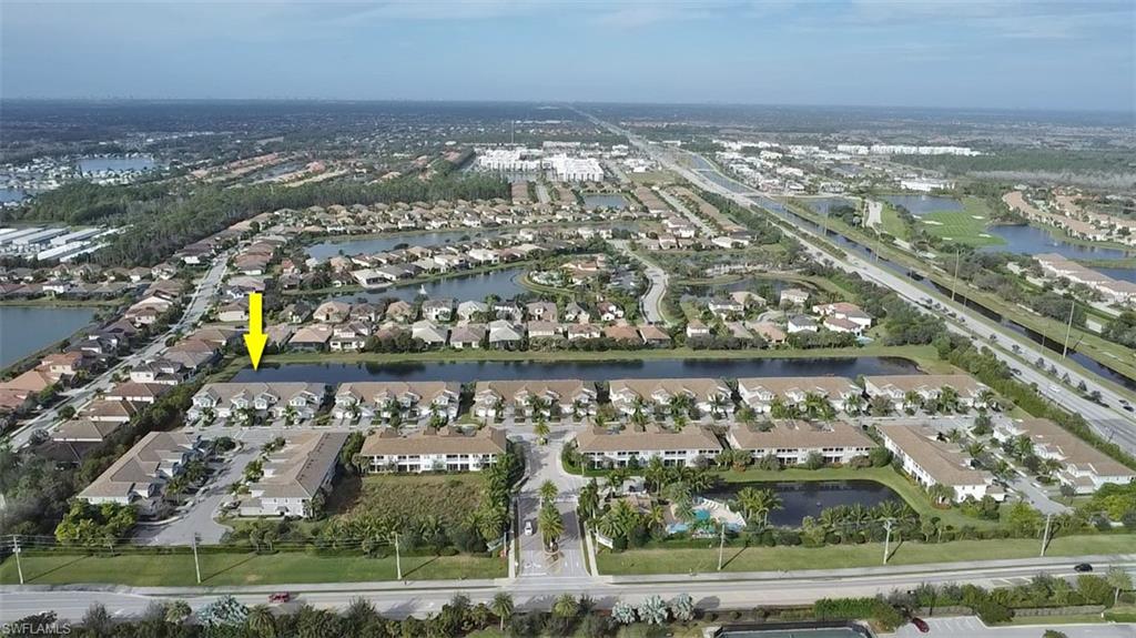 2295 Sawyers Hill Road, Unit 1002 Naples, FL 34120 - Photo 31 of 41 an aerial view of residential building and lake
