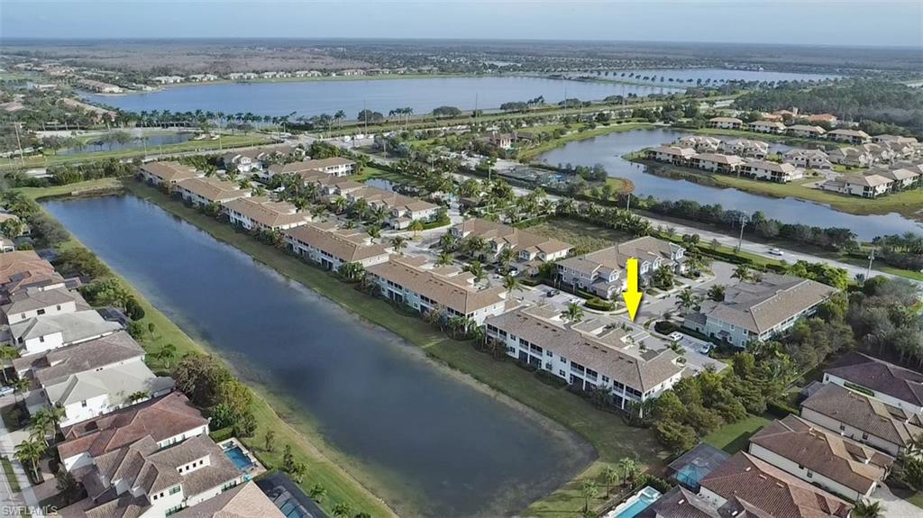 2295 Sawyers Hill Road, Unit 1002 Naples, FL 34120 - Photo 35 of 41 an aerial view of a city with a lake