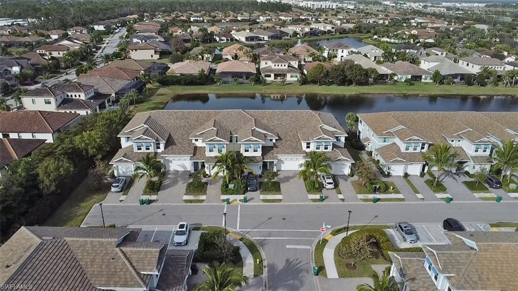 2295 Sawyers Hill Road, Unit 1002 Naples, FL 34120 - Photo 36 of 41 an aerial view of a house with garden space and lake view
