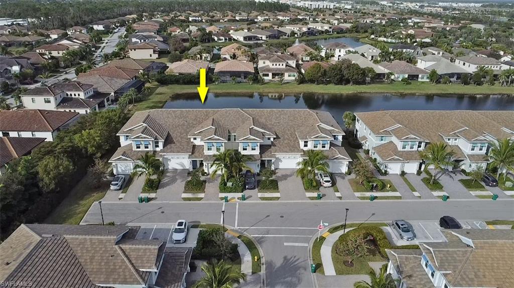 2295 Sawyers Hill Road, Unit 1002 Naples, FL 34120 - Photo 37 of 41 an aerial view of a house with a lake view