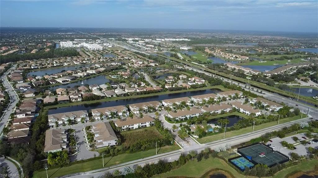 2295 Sawyers Hill Road, Unit 1002 Naples, FL 34120 - Photo 40 of 41 an aerial view of residential building and lake