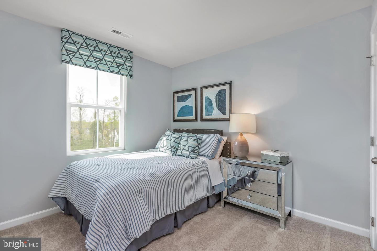 601 Yellow Bill Lane, Unit JUNIPER Cambridge, MD 21613 - Photo 13 of 14 a bedroom with a bed and a window