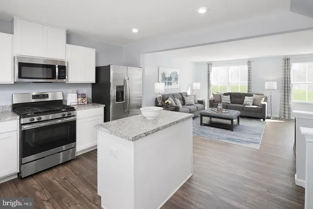 a view of kitchen with sink and refrigerator