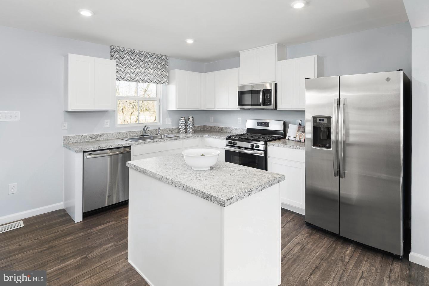 601 Yellow Bill Lane, Unit JUNIPER Cambridge, MD 21613 - Photo 3 of 14 a kitchen with stainless steel appliances granite countertop a refrigerator a sink a stove a microwave and island