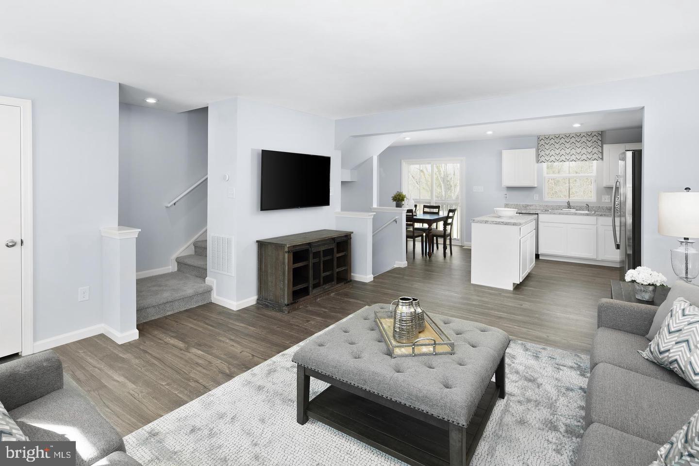 601 Yellow Bill Lane, Unit JUNIPER Cambridge, MD 21613 - Photo 6 of 14 a living room with furniture a fireplace and a flat screen tv