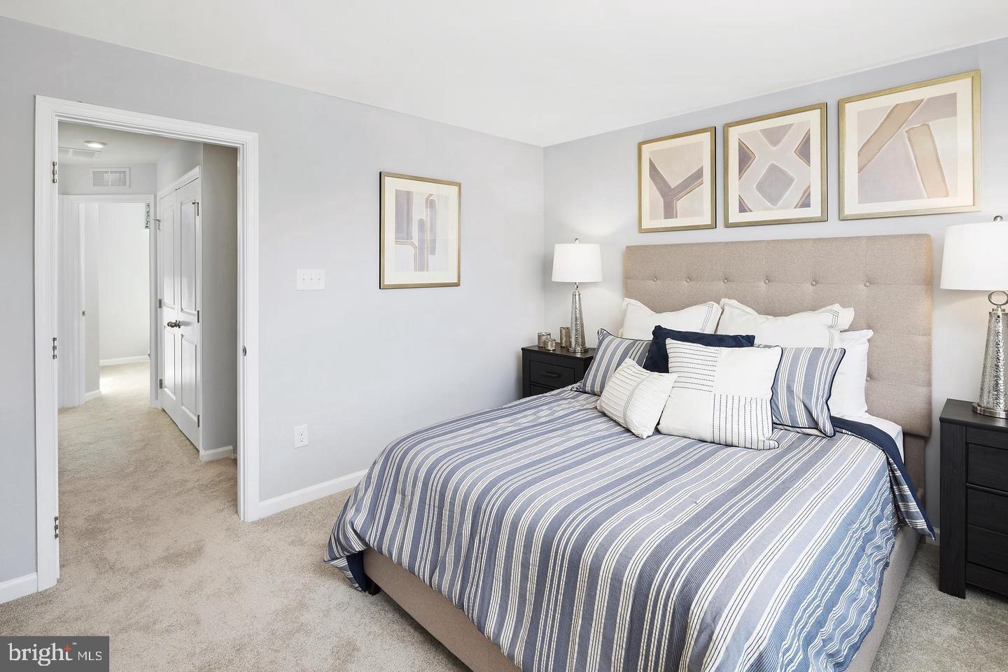 601 Yellow Bill Lane, Unit JUNIPER Cambridge, MD 21613 - Photo 9 of 14 a bedroom with a bed and painting on the wall