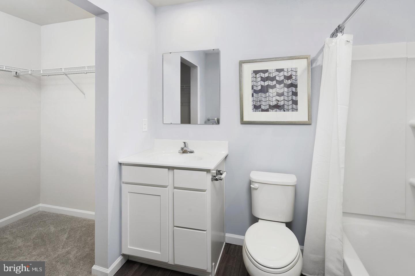 601 Yellow Bill Lane, Unit JUNIPER Cambridge, MD 21613 - Photo 10 of 14 a bathroom with a toilet sink and mirror