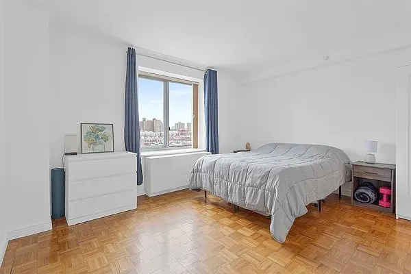 a spacious bedroom with a bed and a window