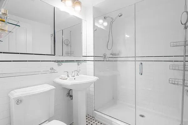 a bathroom with a sink mirror toilet and shower