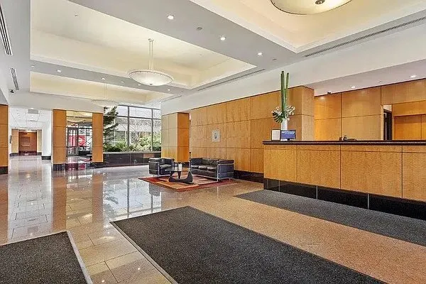 a lobby with furniture and floor to ceiling window