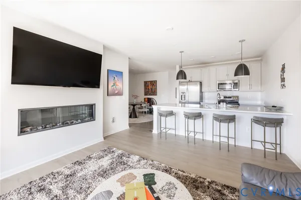 a living room with furniture a flat screen tv and a fireplace