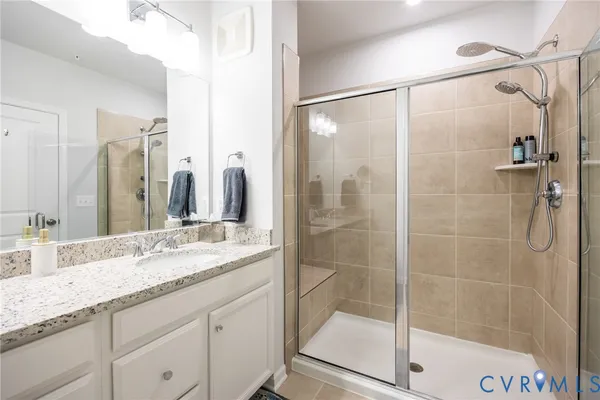a kitchen with a refrigerator and a stove top oven