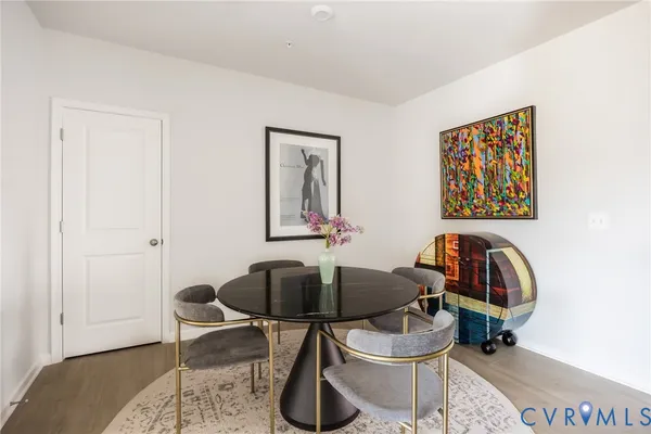 a kitchen with stainless steel appliances granite countertop a sink a stove and a wooden floors