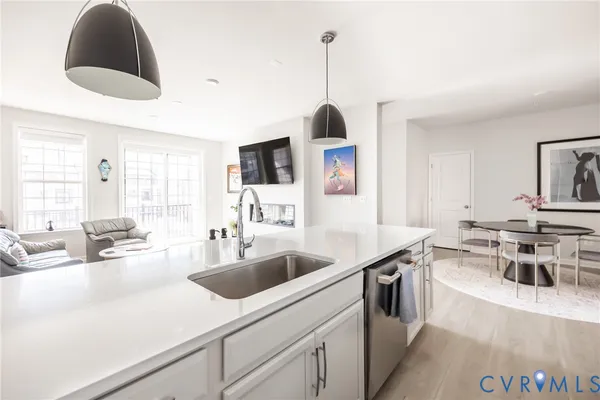 a living room with furniture and kitchen view