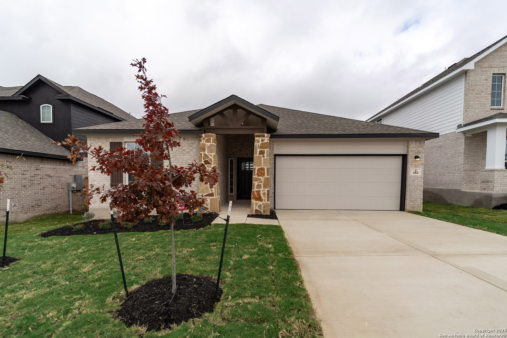 182 Ednie Lane Mico, TX 78056 - Photo 1 of 19 a front view of a house with garden