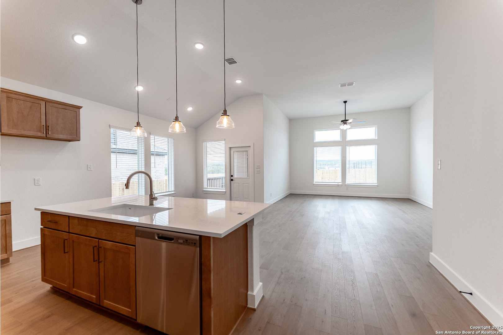 182 Ednie Lane Mico, TX 78056 - Photo 11 of 19 a kitchen with a sink chandelier and wooden floors