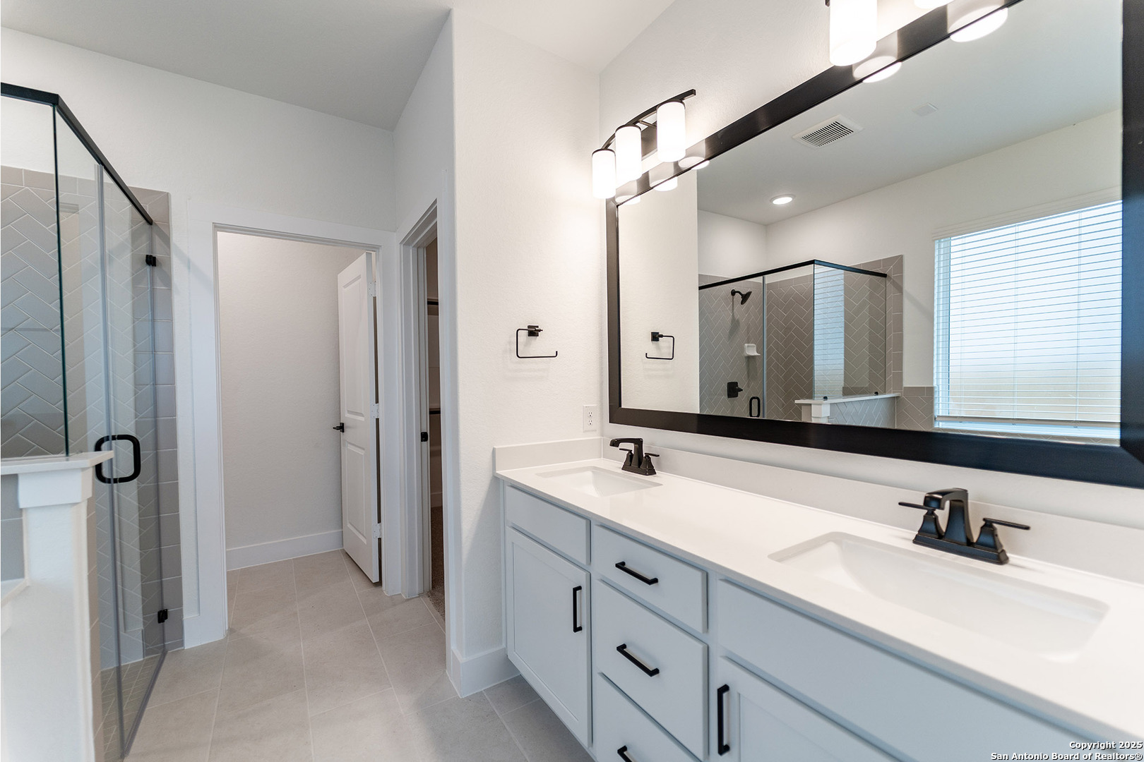 182 Ednie Lane Mico, TX 78056 - Photo 13 of 19 a bathroom with a double vanity sink mirror double and shower