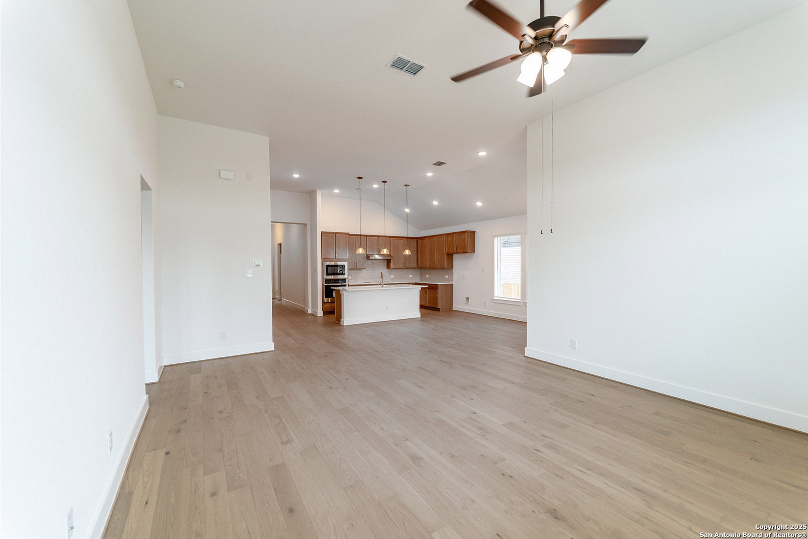 182 Ednie Lane Mico, TX 78056 - Photo 5 of 19 a view of a kitchen with a sink and a refrigerator