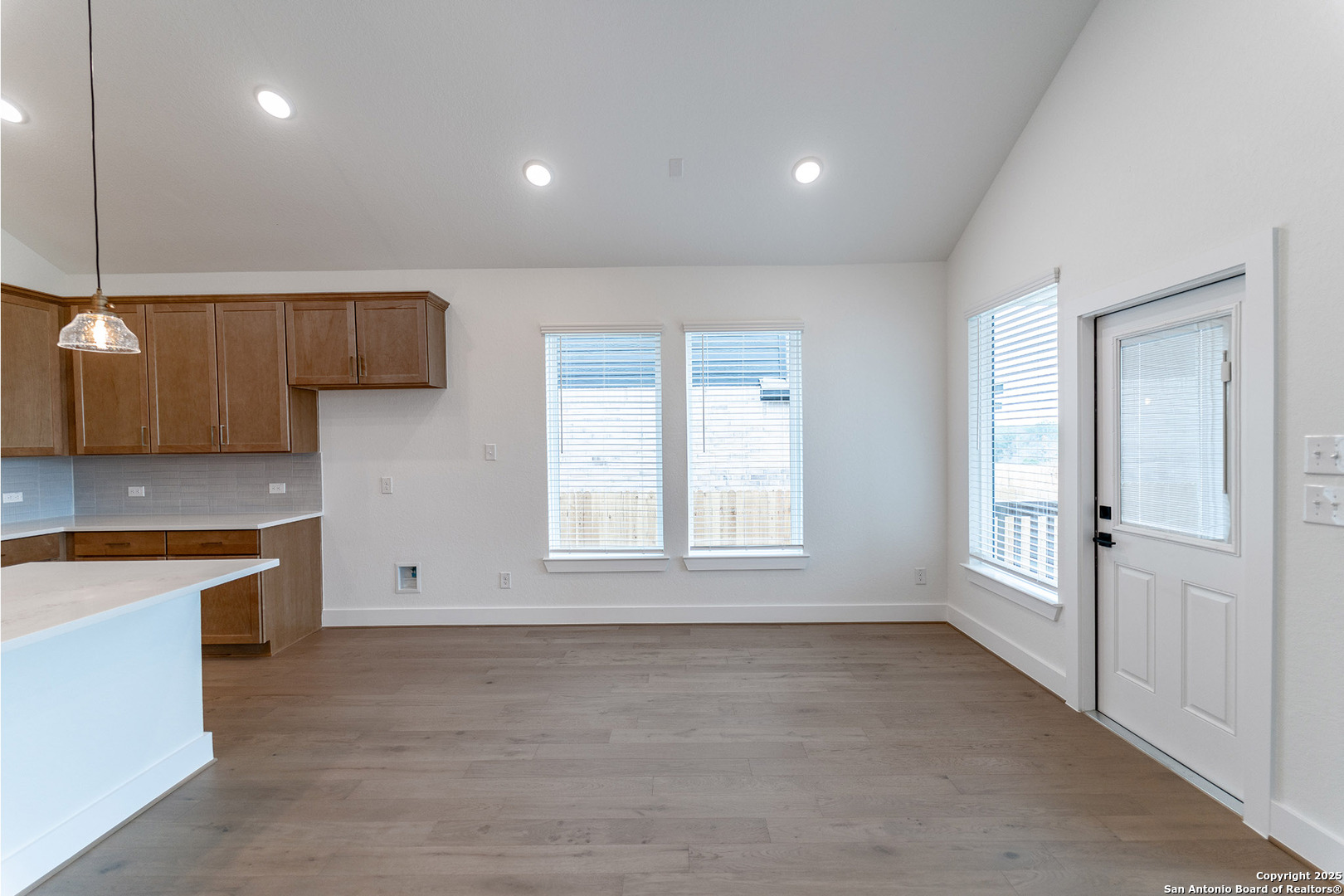 182 Ednie Lane Mico, TX 78056 - Photo 6 of 19 an empty room with a kitchen and a window