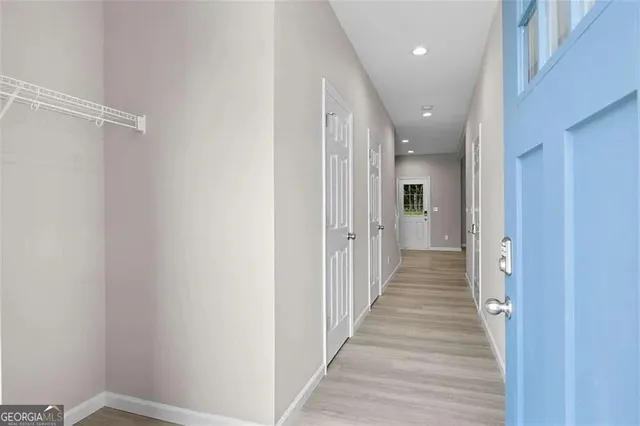 a view of a hallway with wooden floor