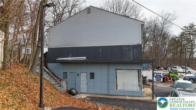 a view of a house with wooden fence