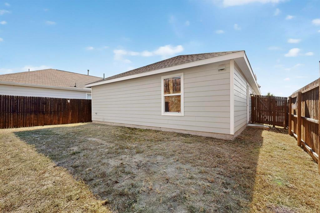 5516 McClelland Street Forney, TX 75126 - Photo 27 of 36 View of home's exterior with a fenced backyard and roof with shingles