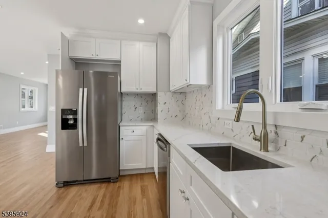 a kitchen with a refrigerator sink and cabinets