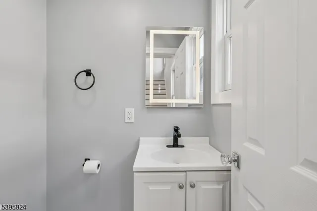 a bathroom with a sink toilet and mirror