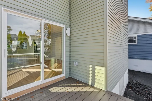 a view of a porch with wooden floor and floor to ceiling window