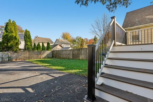 a view of street along with house and trees