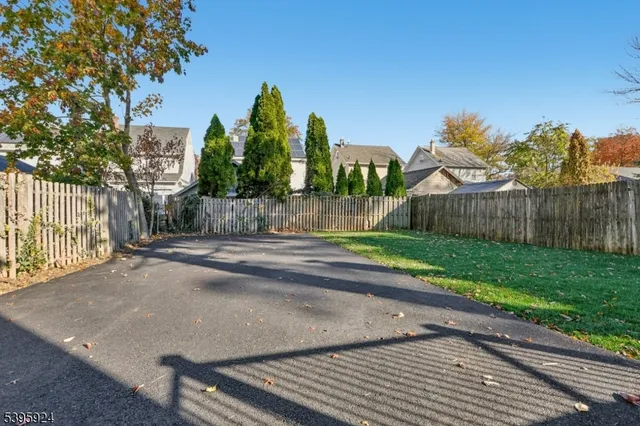 a view of a yard with wooden fence
