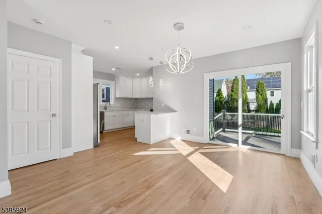 a view of empty room with wooden floor and outdoor view