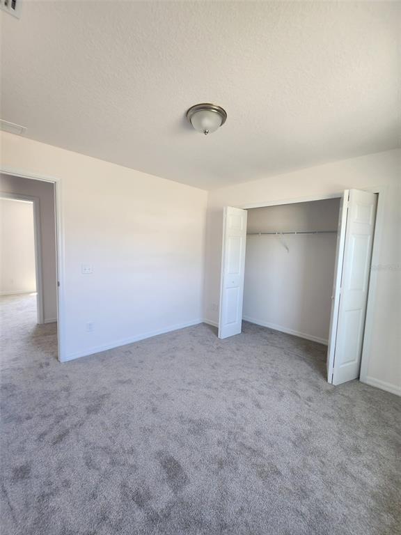 4381 East Ravenna Street Inverness, FL 34453 - Photo 17 of 44 an empty room with a natural light