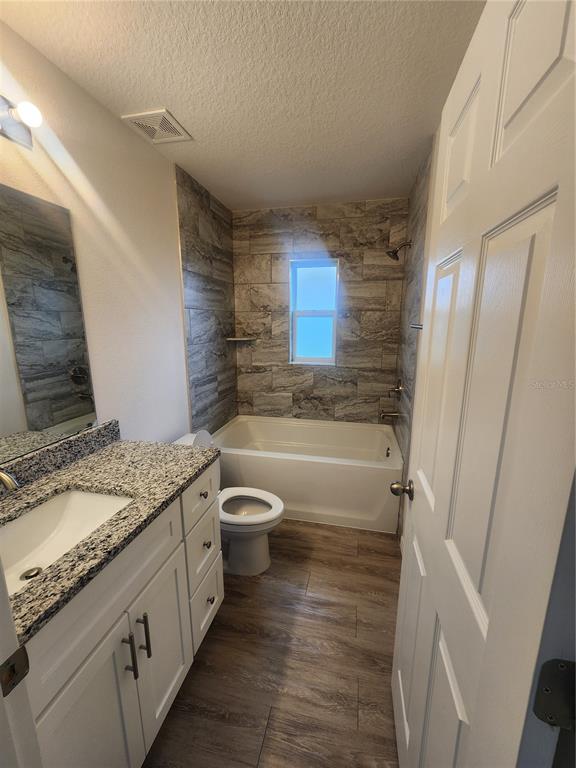 4381 East Ravenna Street Inverness, FL 34453 - Photo 19 of 44 a bathroom with a granite countertop sink toilet and shower