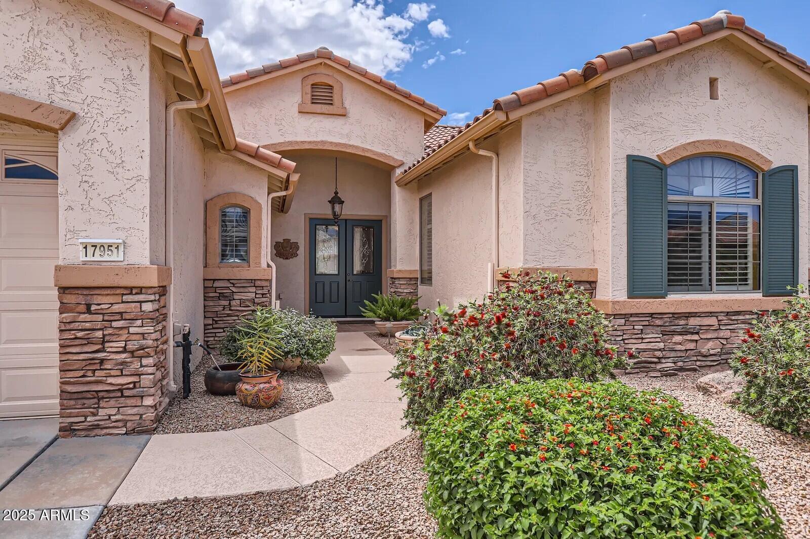 17951 West Sammy Way Surprise, AZ 85374 - Photo 3 of 24 a front view of a house
