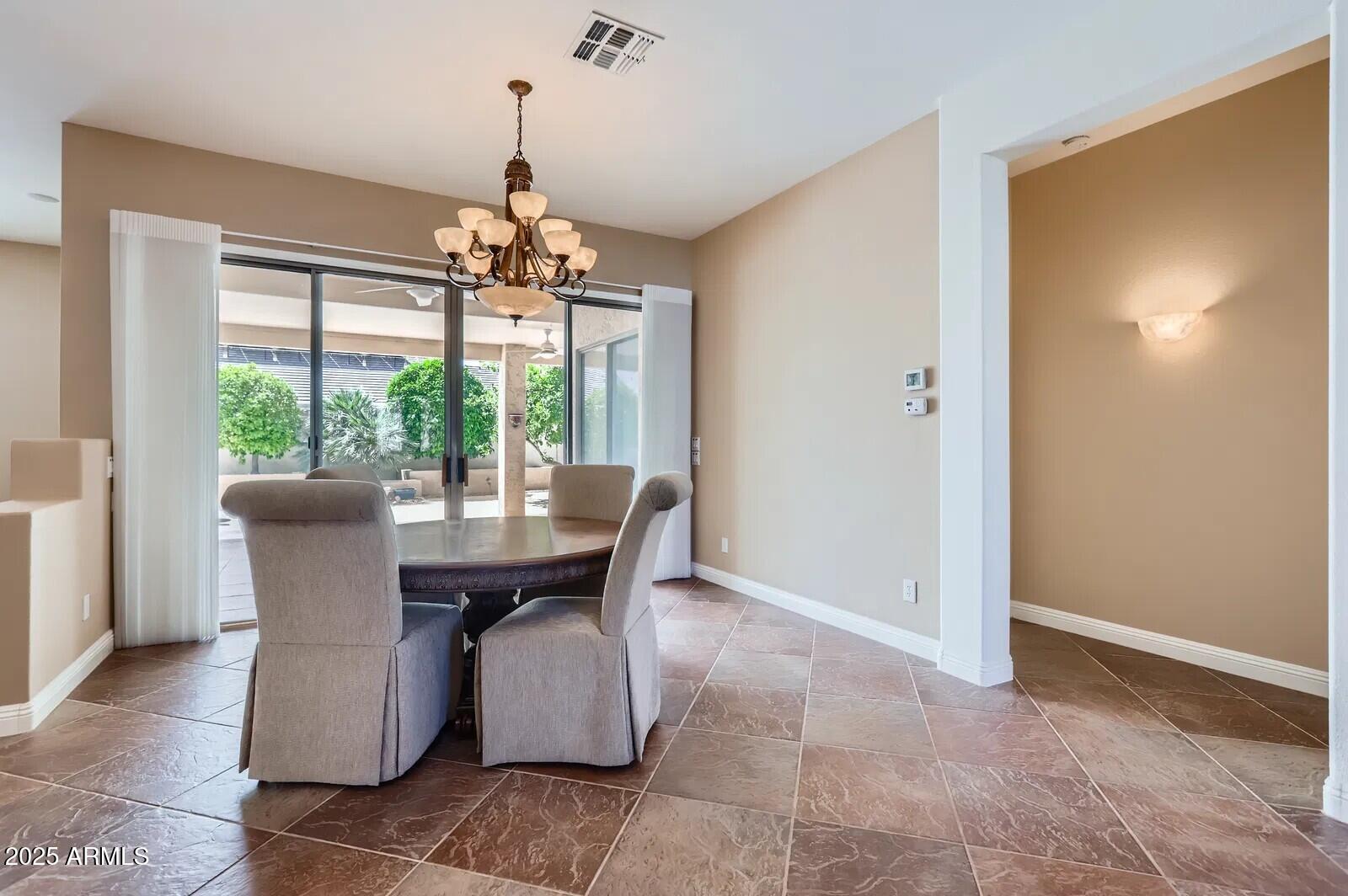 17951 West Sammy Way Surprise, AZ 85374 - Photo 5 of 24 a view of a dining room with furniture wooden floor and chandelier