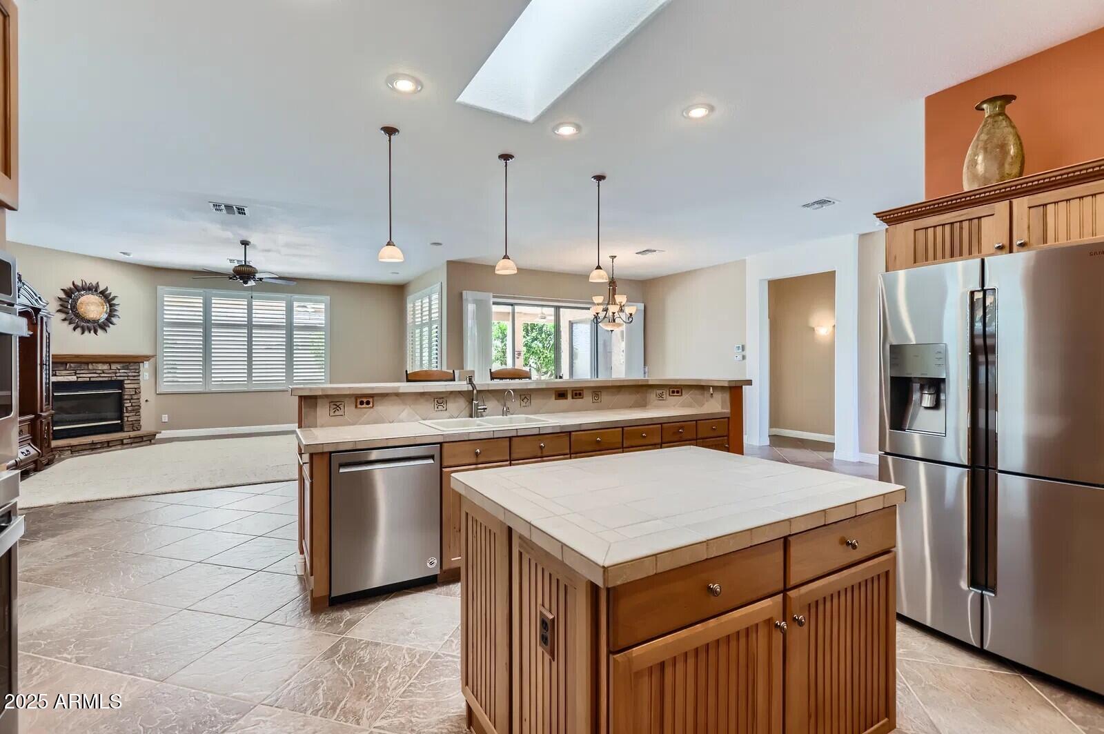 17951 West Sammy Way Surprise, AZ 85374 - Photo 10 of 24 a kitchen with stainless steel appliances a sink a stove a refrigerator and cabinets