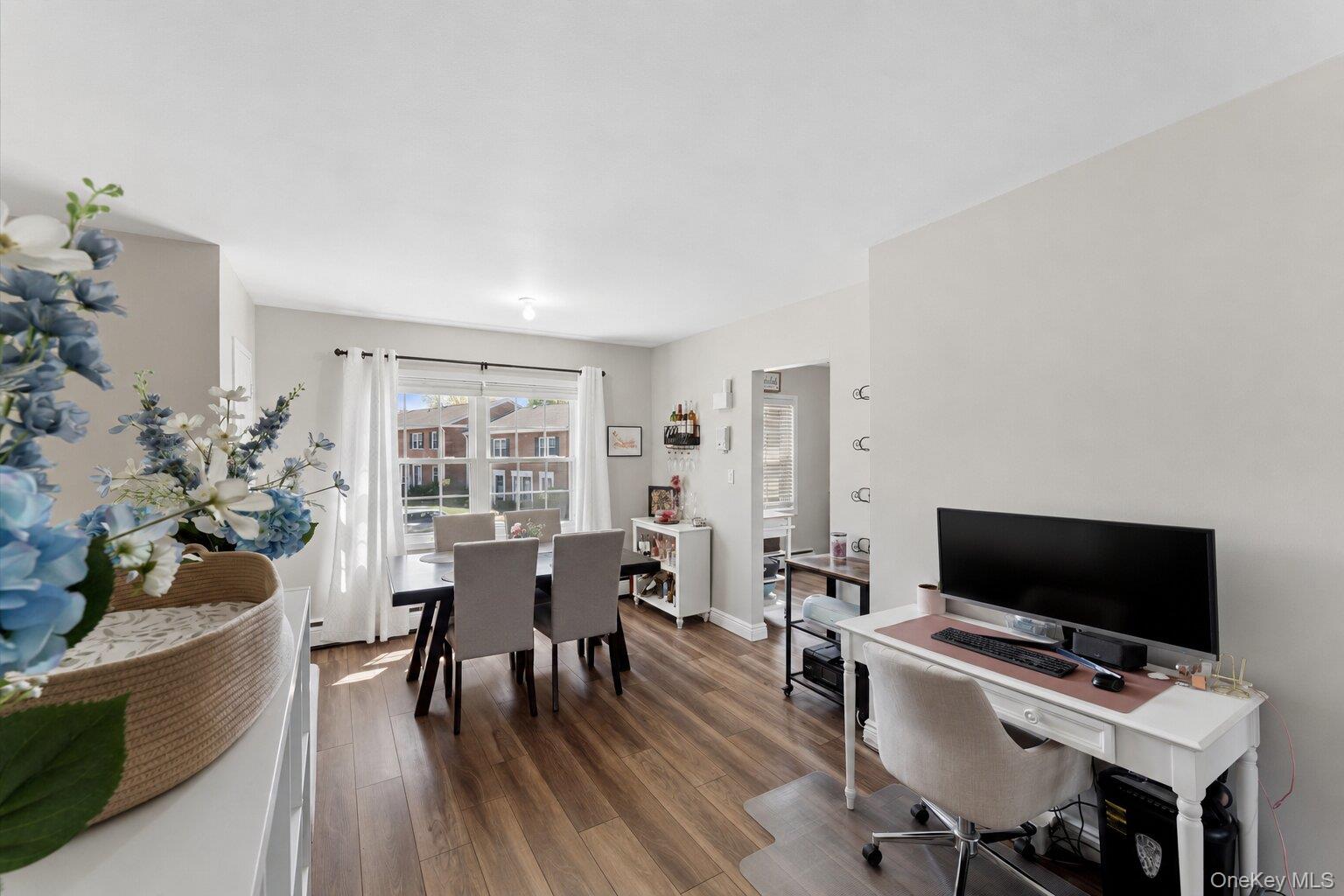 323 Hicksville Road, Unit 4 Bethpage, NY 11714 - Photo 6 of 17 a view of a livingroom with furniture and a flat screen tv
