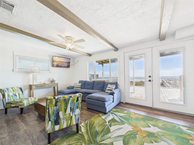 a view of a bedroom with furniture and window